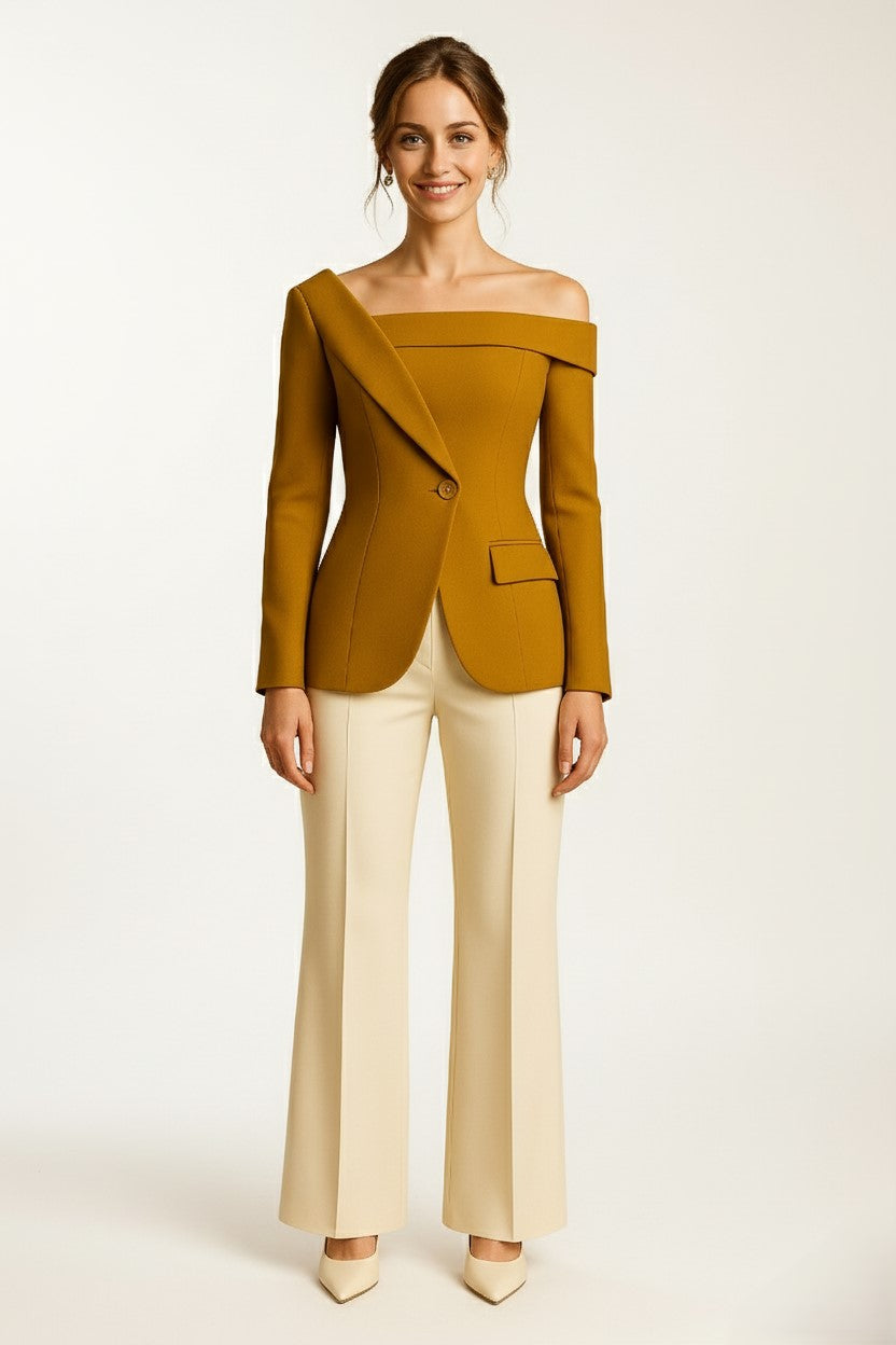 Woman wearing a asymmetrical off-shoulder cashmere top and beige pants on a white background