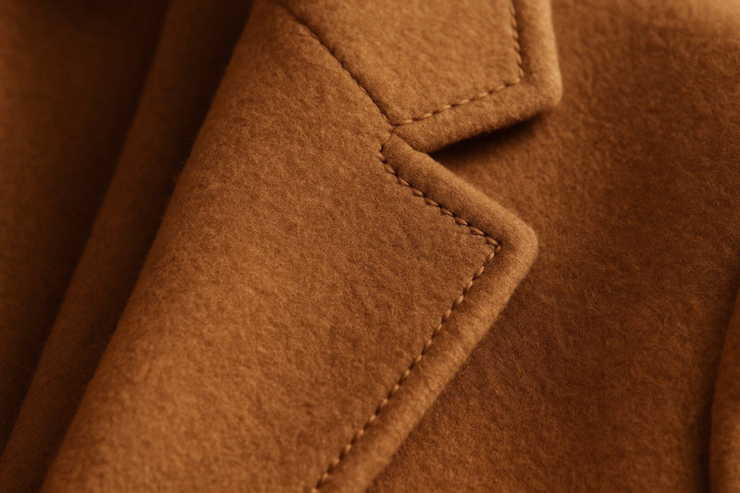 Close-up of a cashmere coat with a focus on texture and stitching.