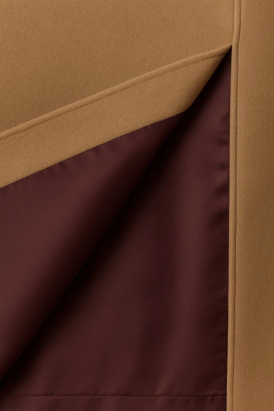 Close-up of beige cashmere with a visible burgundy silk lining