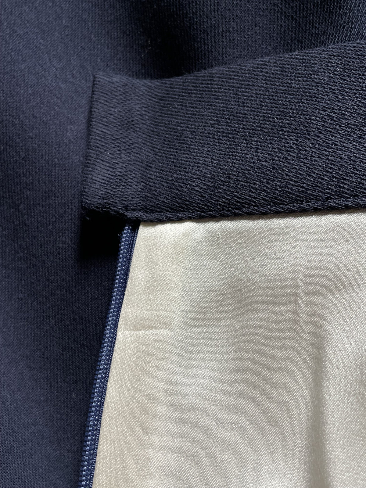 Close-up of midnight blue wool skirt interior silk lining