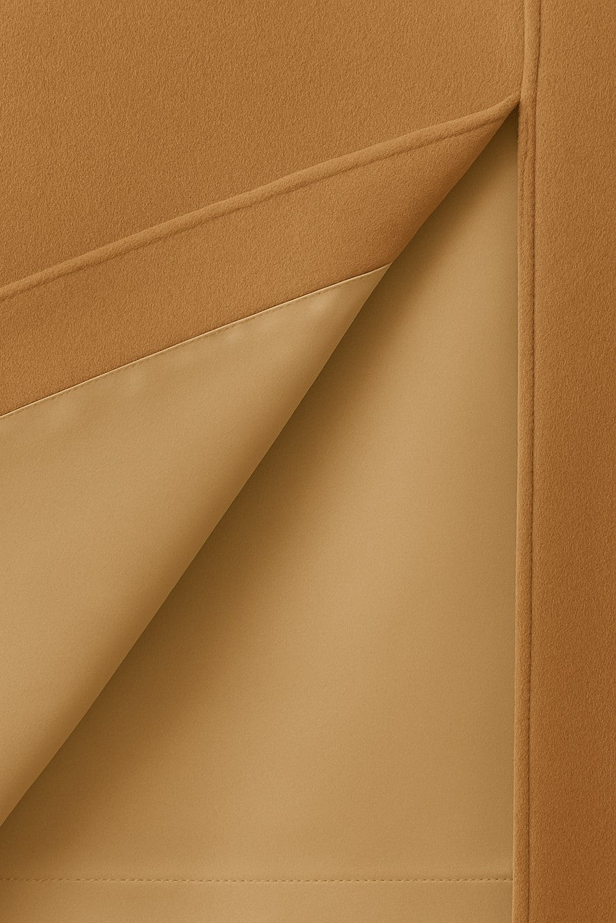 Close-up of beige cashmere with a visible beige silk lining