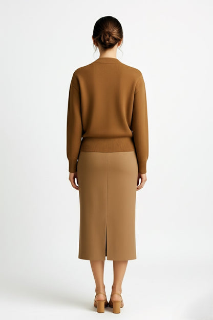 Woman wearing a cashmere cardigan and cashmere pencil skirt on a white background