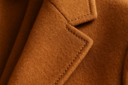 Close-up of a cashmere coat with a focus on texture and stitching.