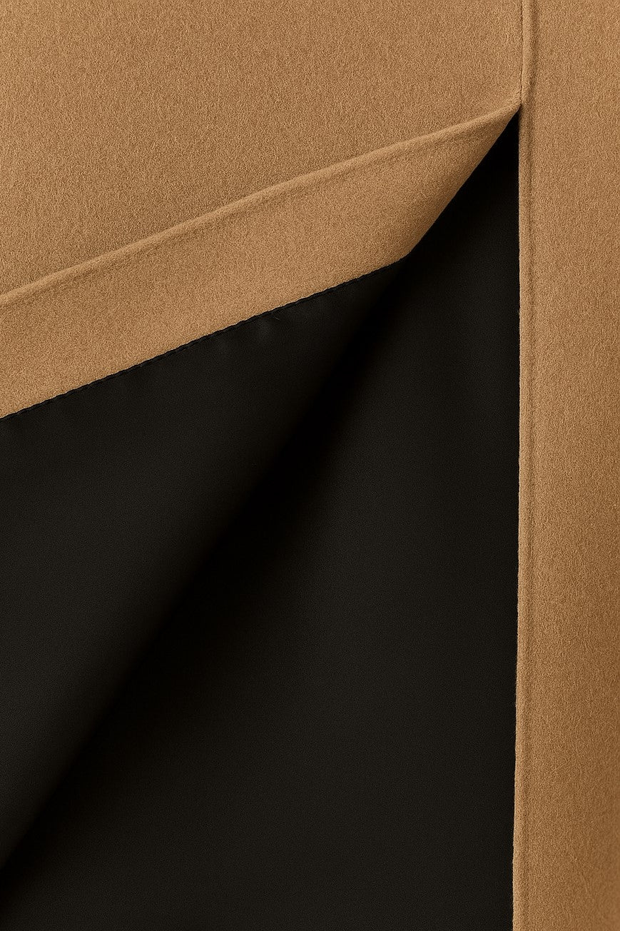 Close-up of beige cashmere with a visible black silk lining