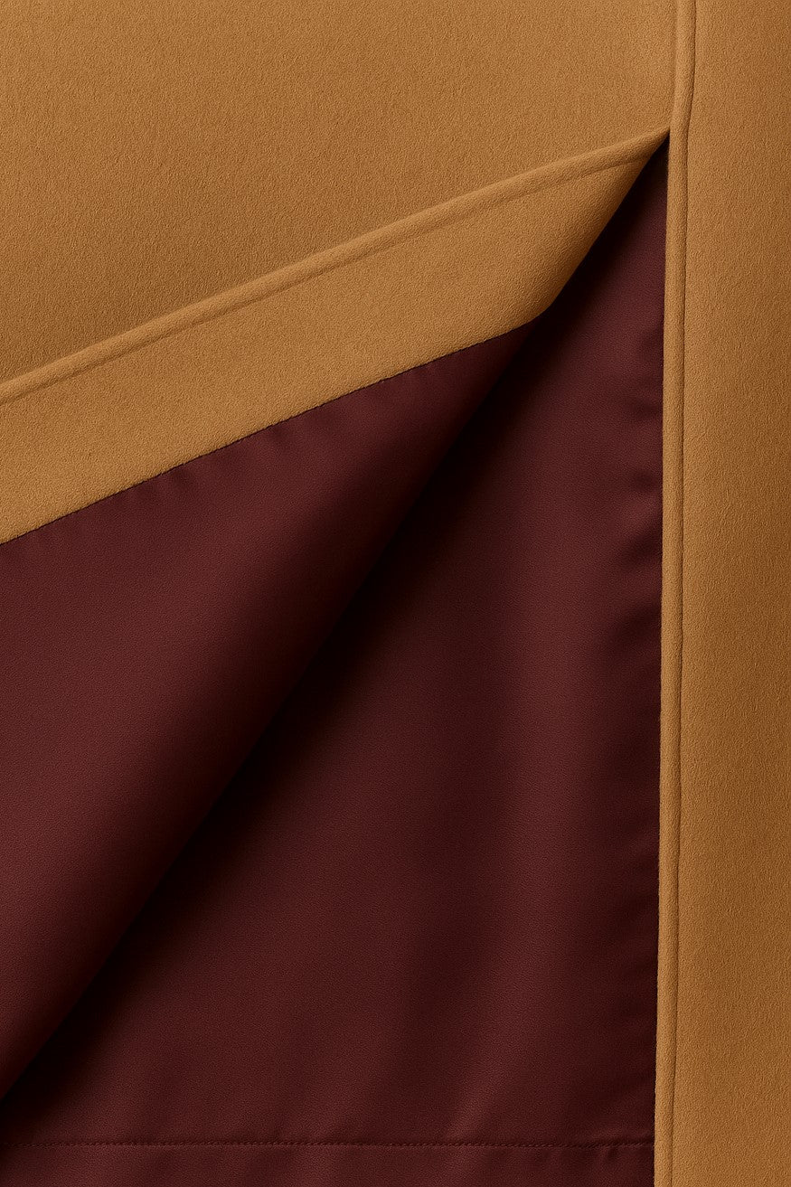 Close-up of beige cashmere with a visible burgundy silk lining