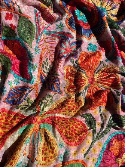 Close-up of colorful embroidered cashmere-silk fabric with floral and butterfly patterns