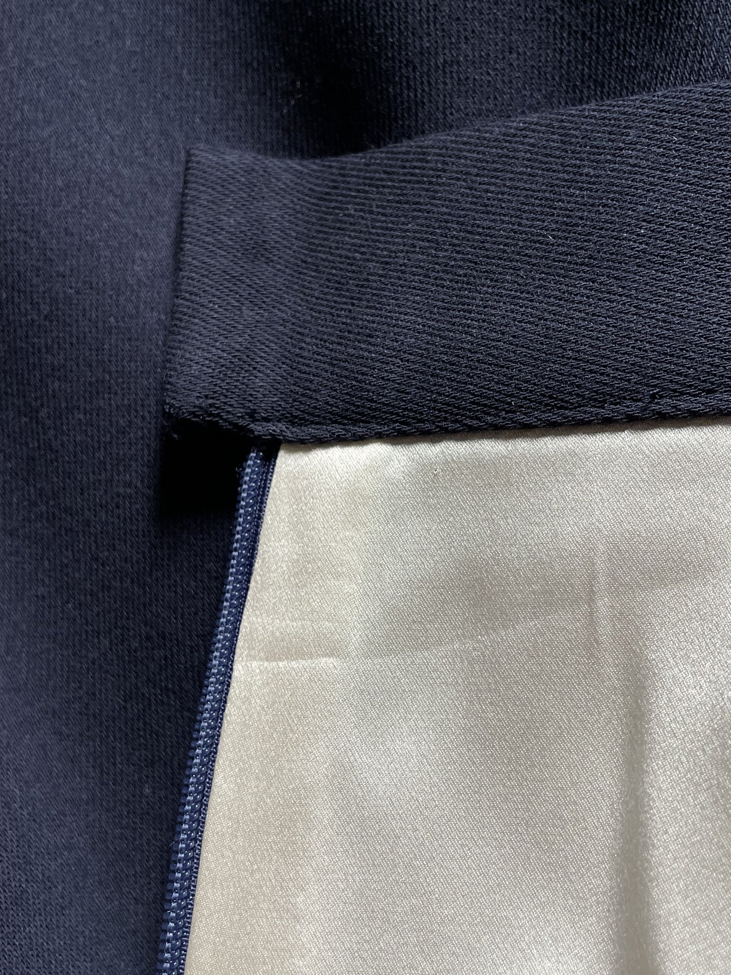 Close-up of midnight blue wool skirt interior silk lining
