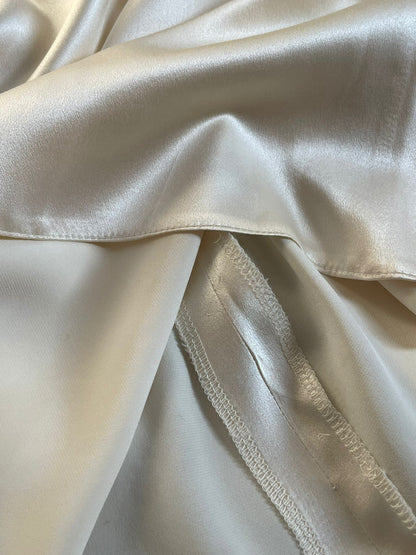 Close up of a champagne mulberry silk dress with overlocked seams.