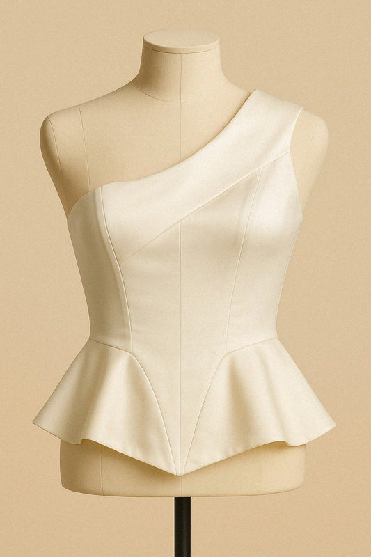 White silk top on a mannequin against a beige background by Bradic.