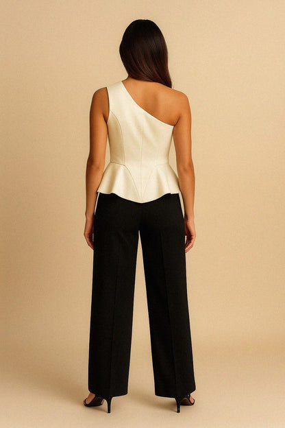 Woman wearing a white one-shoulder silk top and black trousers by Bradic.
